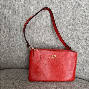 Coach wristlet, orange.